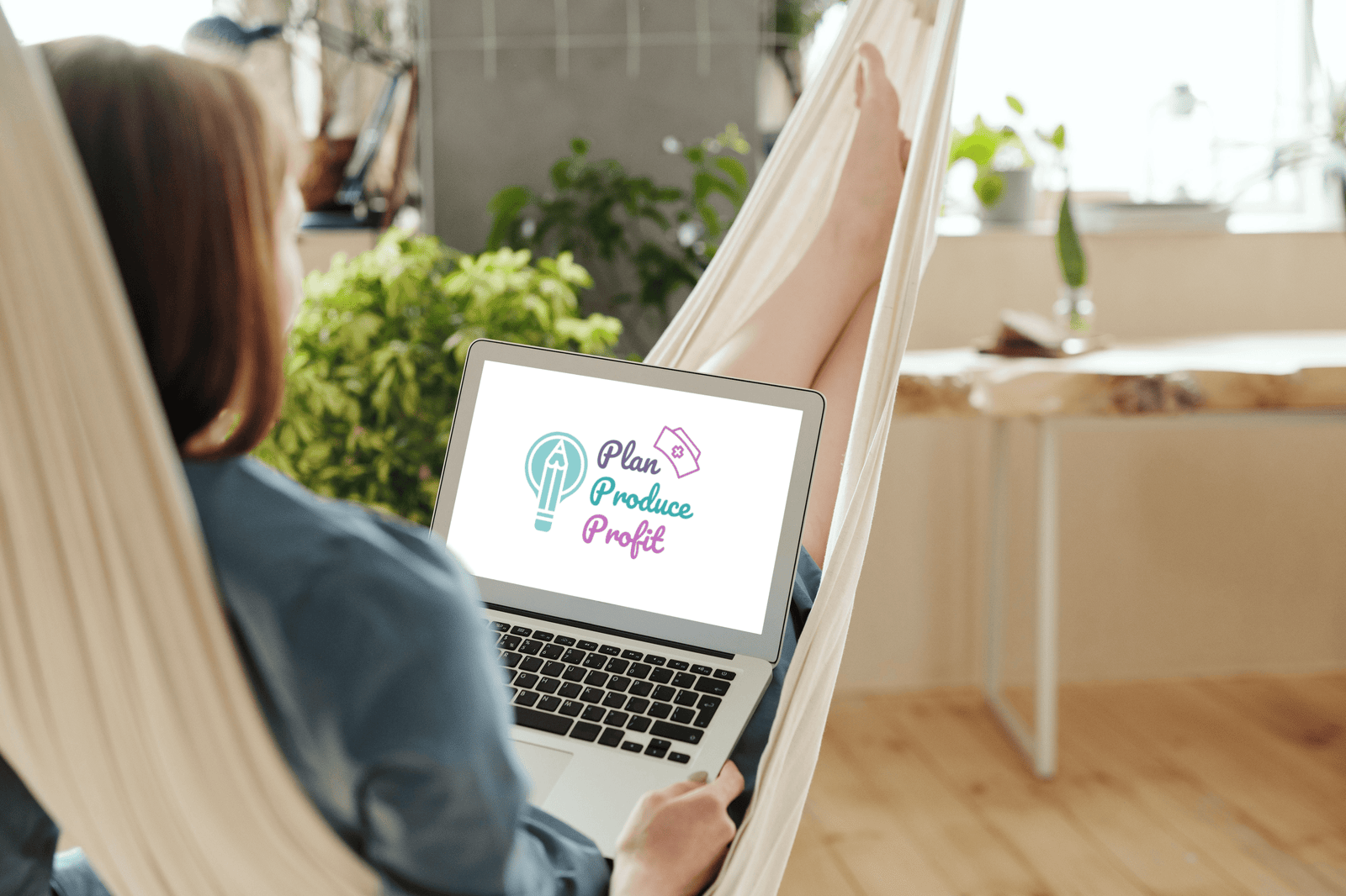 Woman using MacBook Air while sitting in the hammock